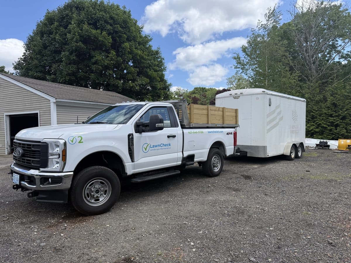 A LawnCheck service truck on site at a property