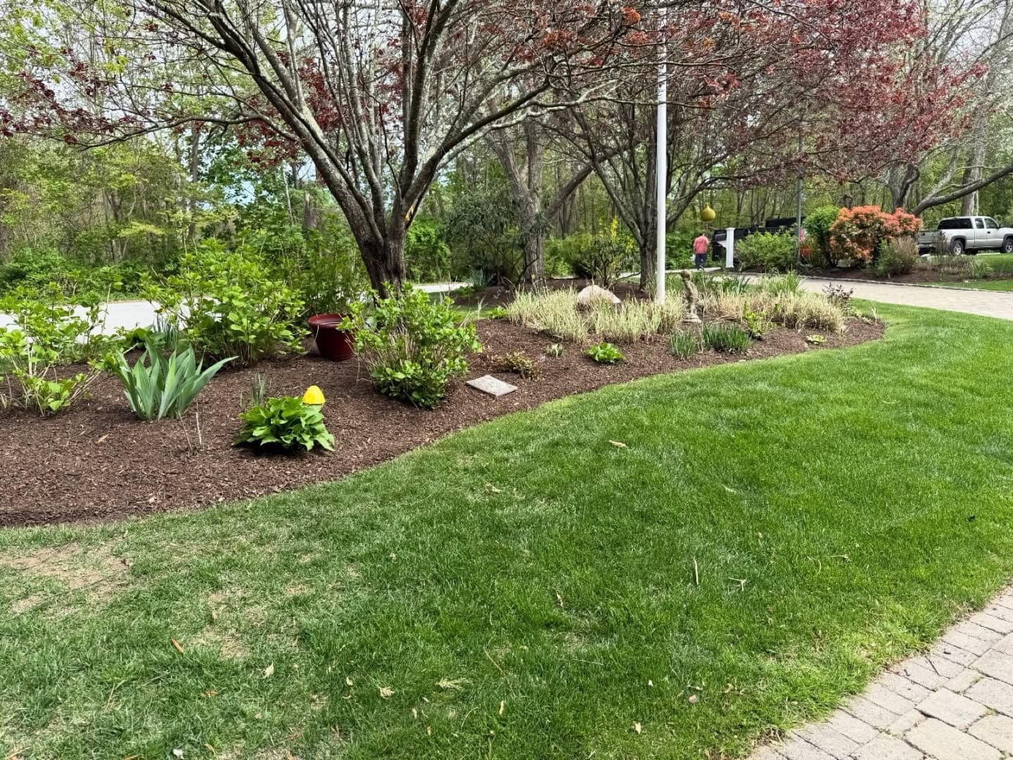 Freshly cleaned and edged planting beds beside a green lawn at an East Bay home