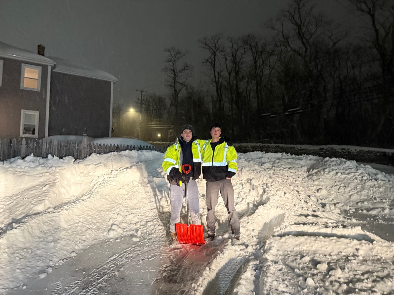 Two LawnCheck crew members after clearing a property during a night storm